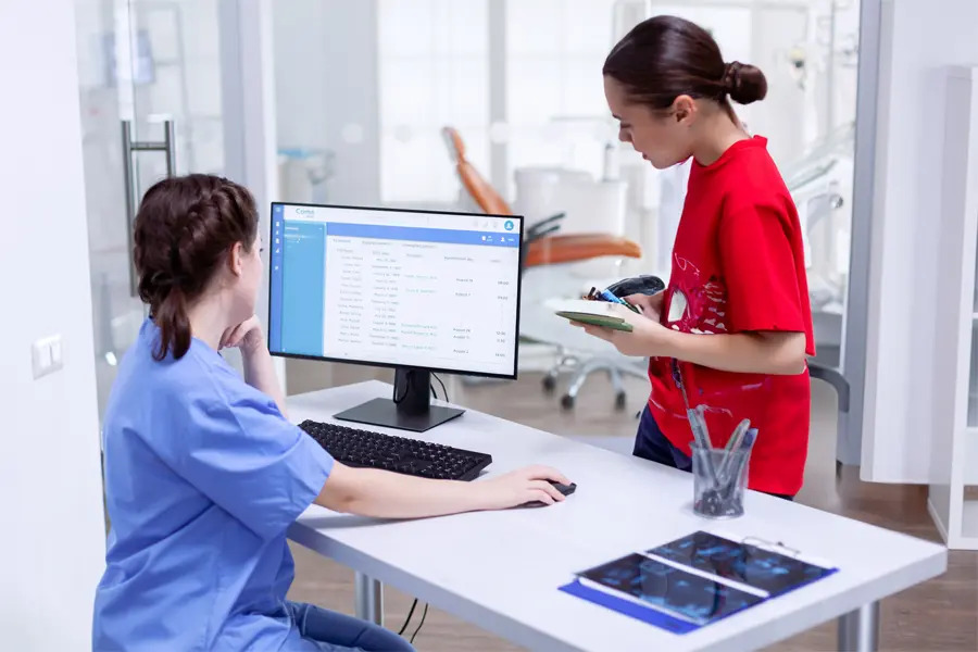 A dental professional reviewing a digital billing system, ensuring clear and straightforward pricing for patients. This image highlights a commitment to transparency in dental care, making it easy for patients to understand costs and plan treatments without unexpected fees.